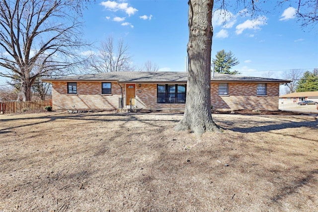 single story home featuring brick siding and fence