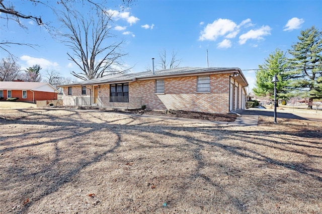 back of property featuring brick siding