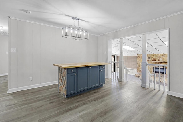 interior space featuring baseboards, ornamental molding, and dark wood finished floors