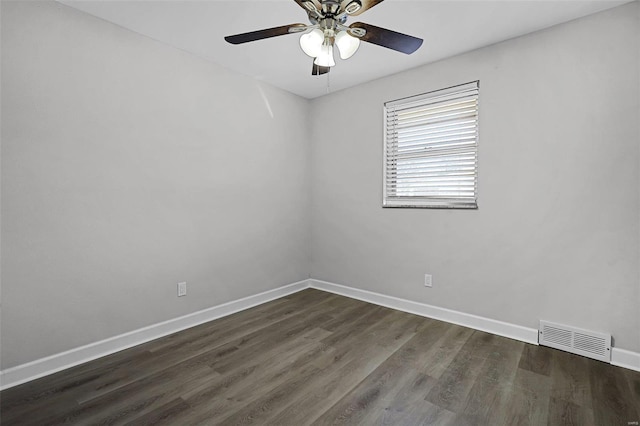 unfurnished room featuring dark wood-type flooring, visible vents, ceiling fan, and baseboards