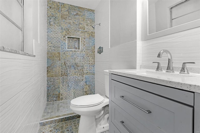 full bathroom with toilet, vanity, tile walls, tiled shower, and decorative backsplash