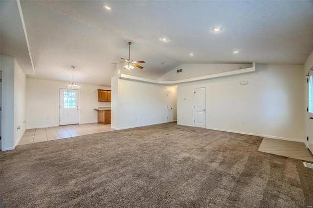 unfurnished living room featuring light tile patterned floors, lofted ceiling, light carpet, visible vents, and a ceiling fan