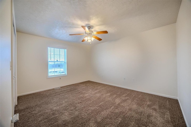 carpeted empty room featuring a textured ceiling, baseboards, and a ceiling fan