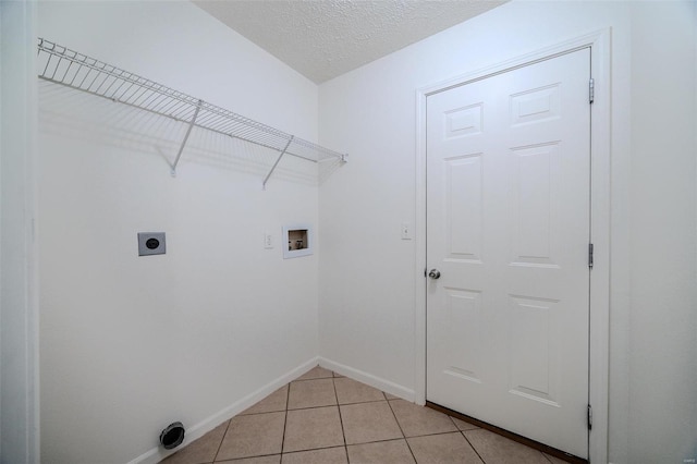 clothes washing area featuring light tile patterned floors, laundry area, baseboards, hookup for an electric dryer, and washer hookup