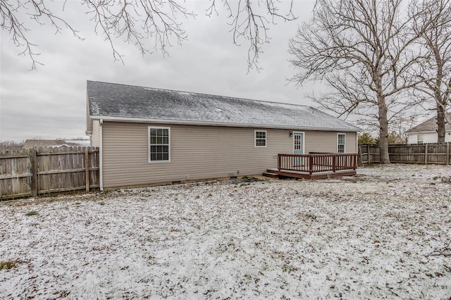 rear view of property with a shingled roof, a fenced backyard, and a wooden deck