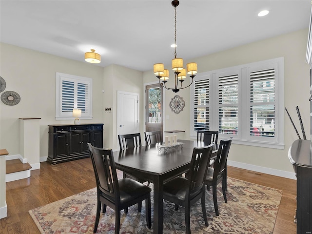 dining room with baseboards, a chandelier, dark wood-type flooring, and recessed lighting