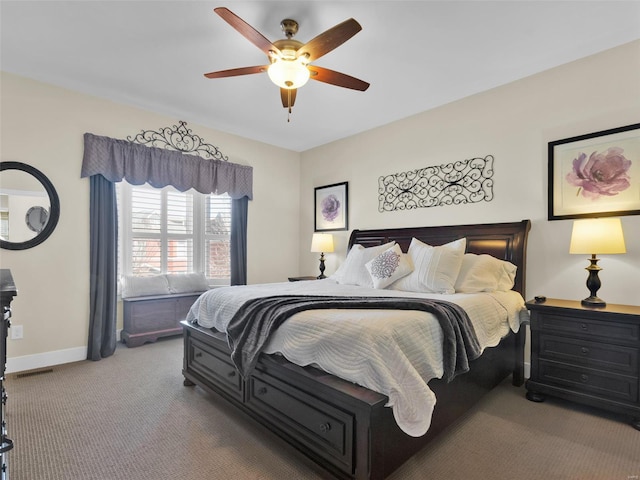 bedroom with ceiling fan, baseboards, and carpet flooring