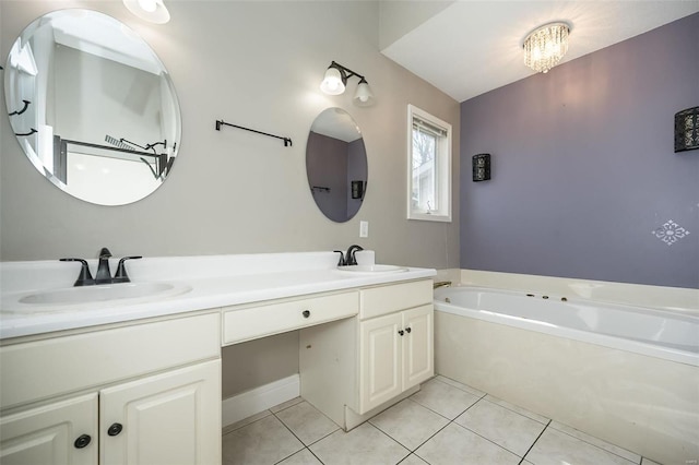 bathroom with tile patterned floors, double vanity, a garden tub, and a sink