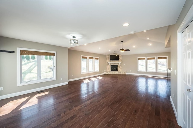 unfurnished living room with lofted ceiling, dark wood-style floors, a fireplace, and baseboards