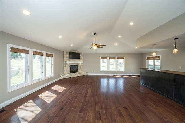 unfurnished living room featuring visible vents, baseboards, lofted ceiling, a fireplace, and dark wood-style floors