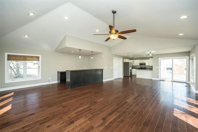 unfurnished living room with high vaulted ceiling, a ceiling fan, recessed lighting, baseboards, and dark wood-style flooring