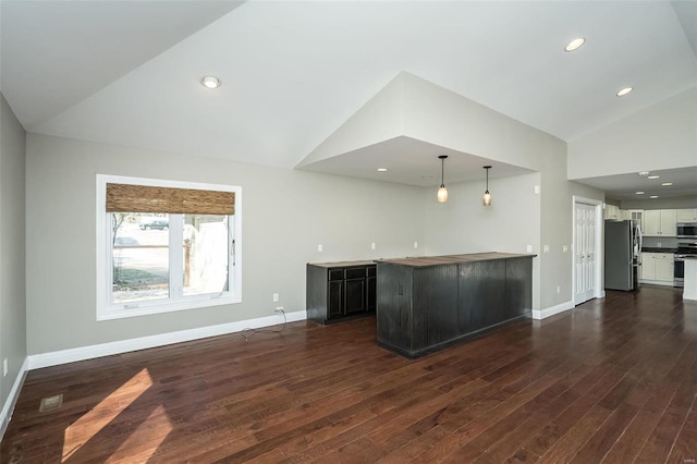 kitchen featuring white cabinets, stainless steel appliances, dark wood-type flooring, and baseboards