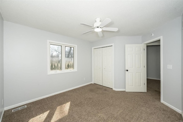 unfurnished bedroom featuring visible vents, baseboards, ceiling fan, carpet flooring, and a closet