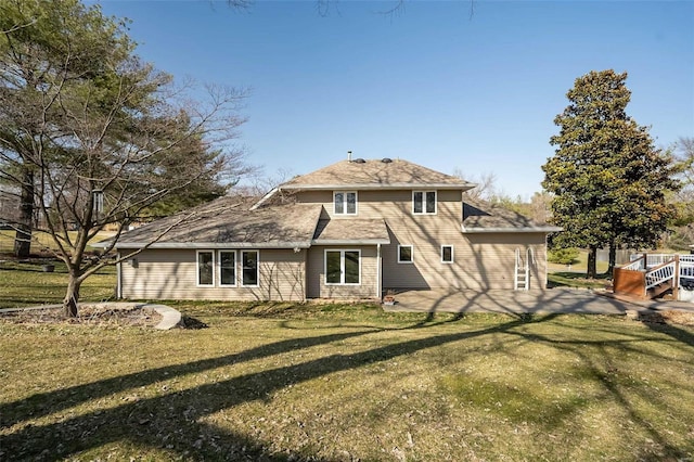 rear view of house with a lawn and a patio area