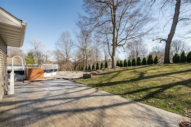 wooden terrace with a lawn