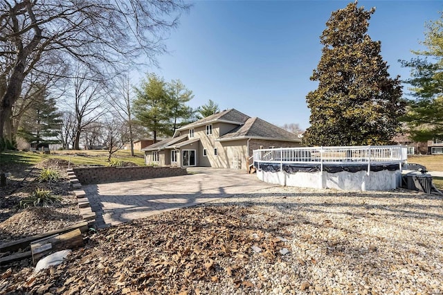 exterior space with a covered pool and driveway