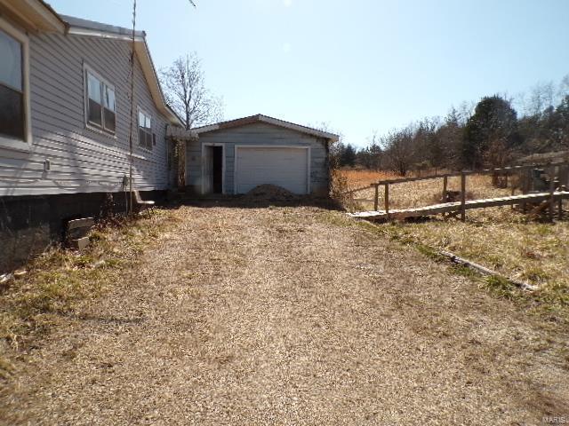 view of property exterior with a detached garage