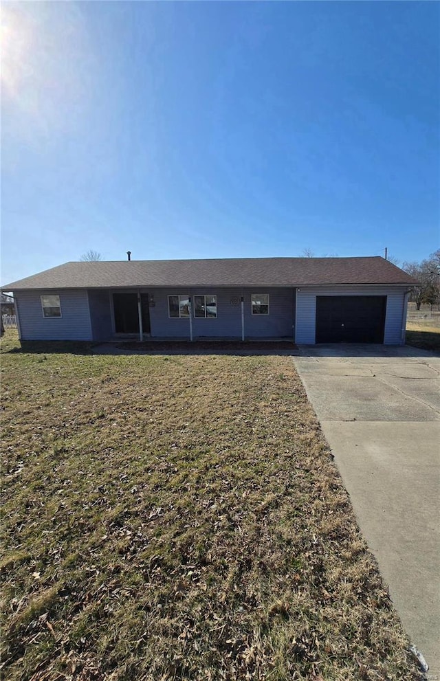 ranch-style house with driveway, a front lawn, and a garage