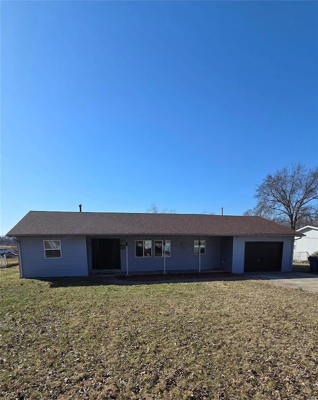 ranch-style house with driveway, a front yard, and an attached garage