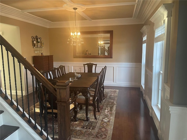 dining space featuring dark wood finished floors, a decorative wall, stairway, wainscoting, and a chandelier