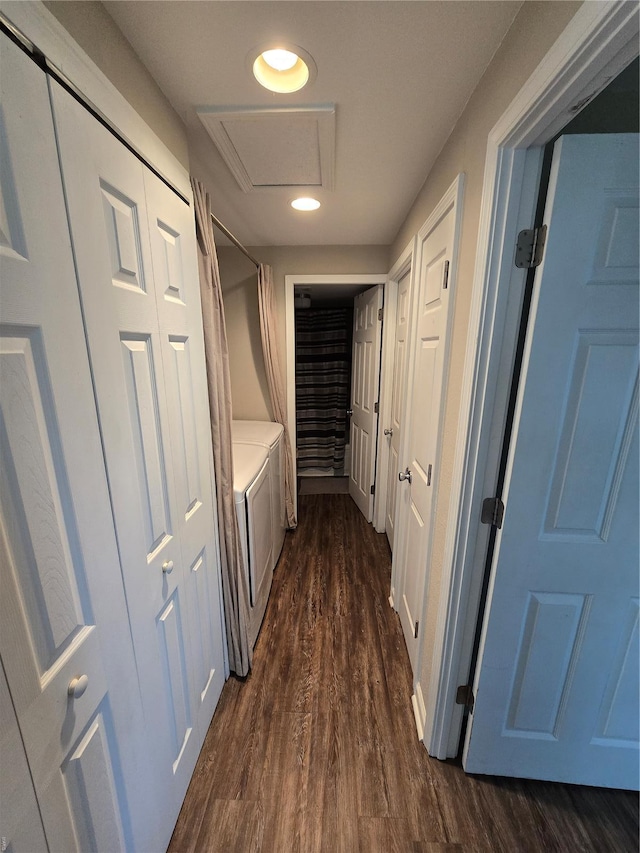 corridor with recessed lighting, attic access, dark wood-style floors, and washer and clothes dryer