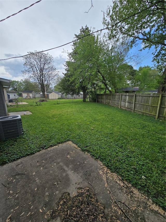 view of yard featuring fence and cooling unit