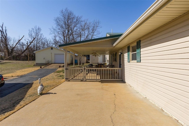 exterior space with an outbuilding, driveway, and a detached garage