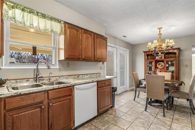 kitchen featuring an inviting chandelier, white dishwasher, brown cabinets, and a sink