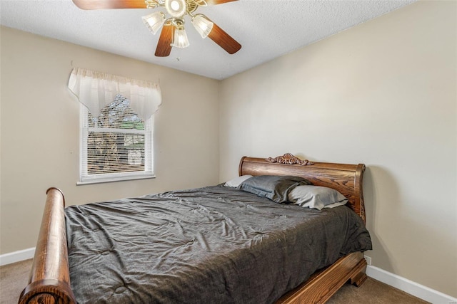 carpeted bedroom with a ceiling fan, a textured ceiling, and baseboards