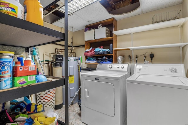 laundry area with water heater, laundry area, light tile patterned floors, and washer and clothes dryer