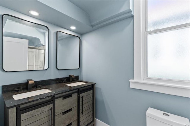 full bath featuring recessed lighting, a sink, toilet, and double vanity