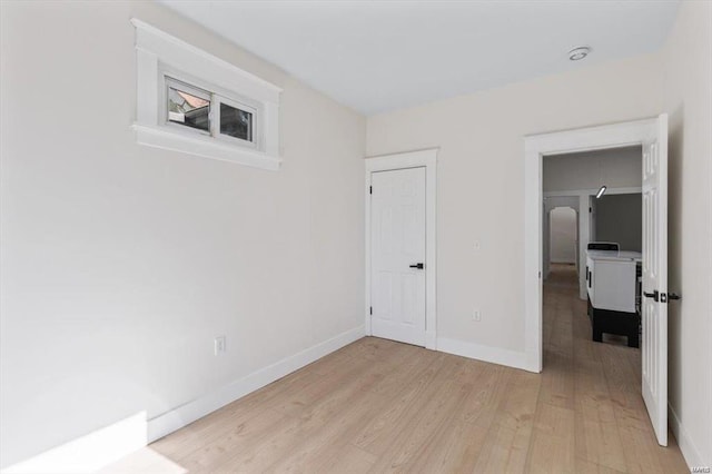 unfurnished bedroom featuring light wood-type flooring and baseboards