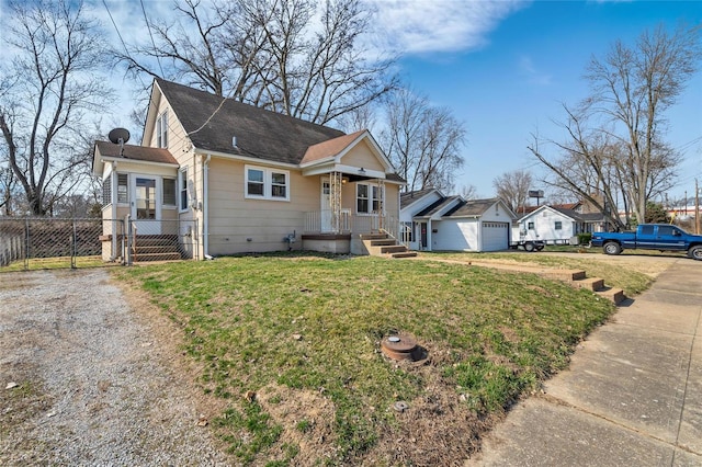 bungalow-style home featuring a garage, a front yard, and fence