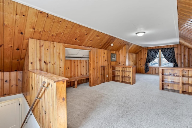 bonus room featuring wooden walls, carpet flooring, and vaulted ceiling