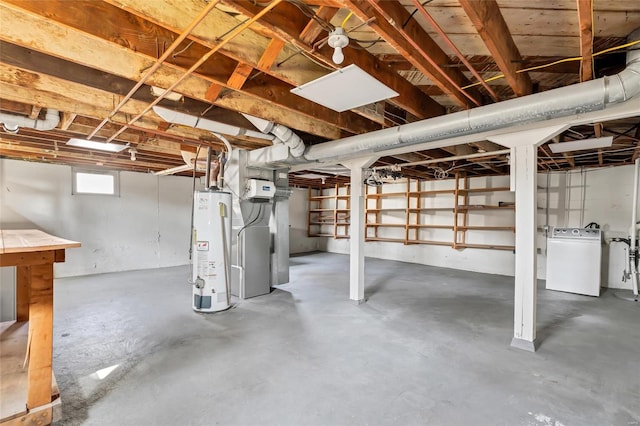 below grade area featuring washer / clothes dryer and water heater