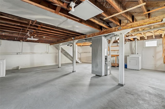 basement featuring stairway and washer / dryer