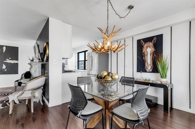 dining room with an inviting chandelier and wood finished floors