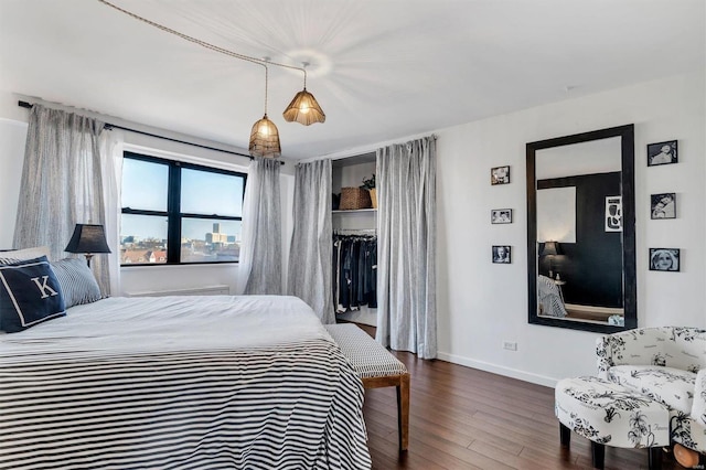 bedroom featuring baseboards and wood finished floors