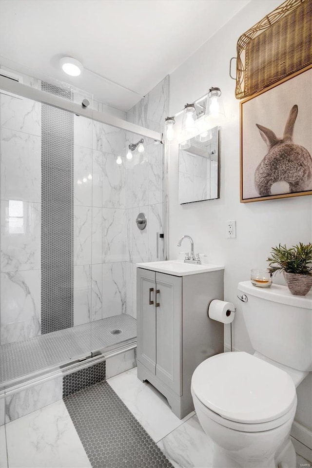 bathroom with a marble finish shower, toilet, marble finish floor, and vanity