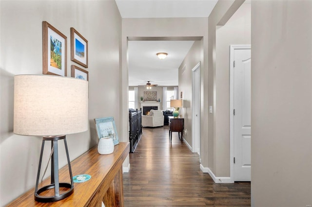 corridor featuring visible vents, dark wood finished floors, and baseboards