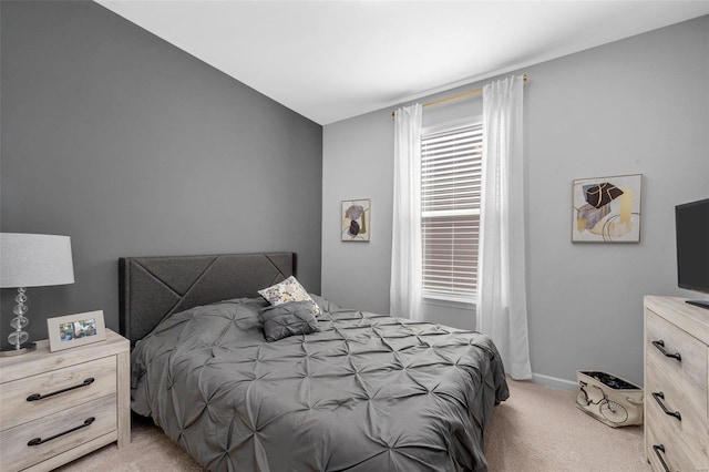 bedroom with light carpet and baseboards