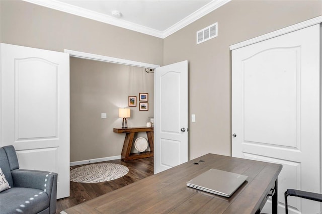 office with ornamental molding, wood finished floors, visible vents, and baseboards