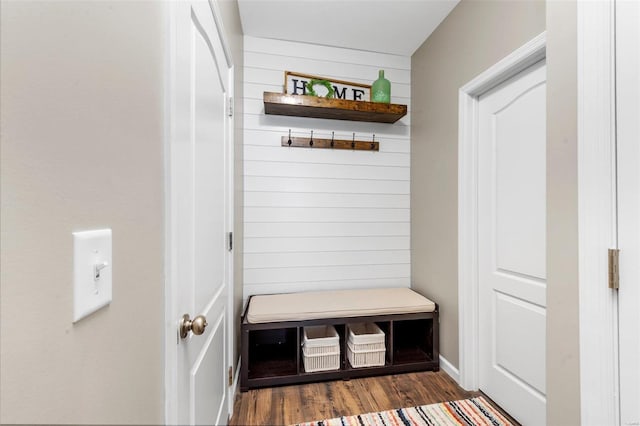 mudroom featuring wooden walls and wood finished floors