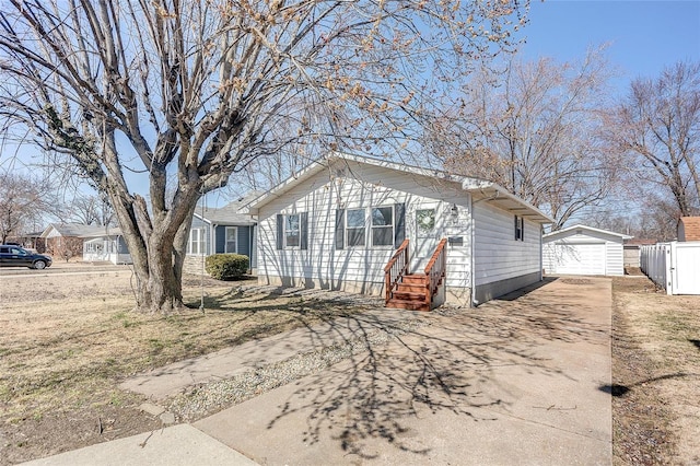 view of front of house with a garage, an outbuilding, and concrete driveway