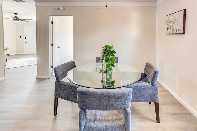 dining space featuring visible vents, baseboards, ceiling fan, and light wood finished floors