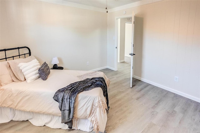 bedroom with baseboards and wood finished floors