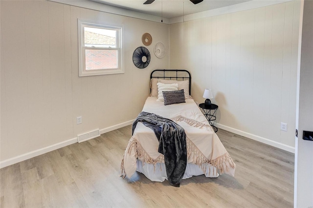 bedroom with visible vents, ceiling fan, baseboards, and wood finished floors