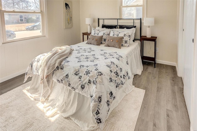 bedroom featuring baseboards and wood finished floors