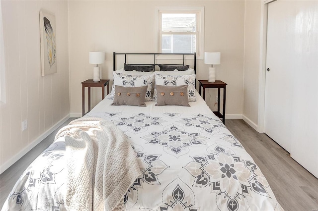 bedroom with wood finished floors and baseboards