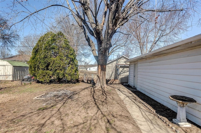 view of yard with an outdoor structure and fence